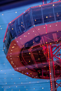 Low angle view of illuminated ferris wheel at night