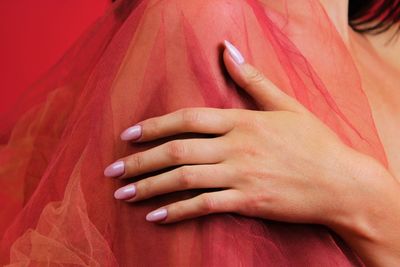 Close-up of woman touching red fabric