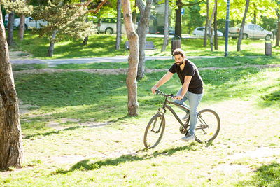 Man riding bicycle on field