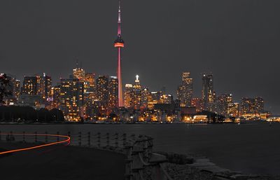 Illuminated buildings against sky at night