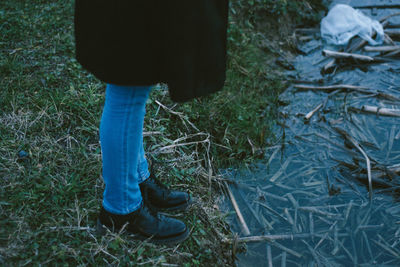 Low section of person standing on field