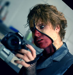 Low angle view of man with halloween make-up looking at camera