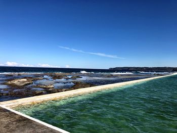 Scenic view of sea against clear blue sky