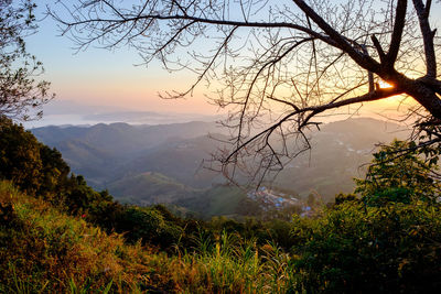 Scenic view of mountains against sky at sunset