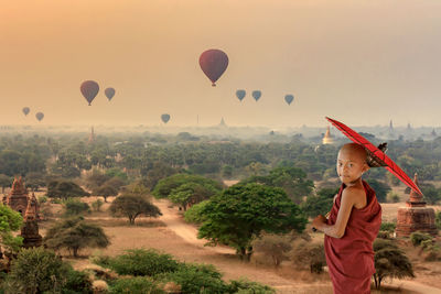 Scenic view of hot air balloons against sky during sunset