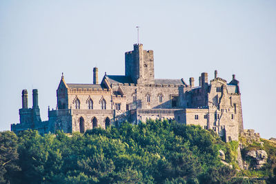 Old buildings in city against clear sky