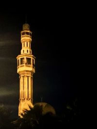 Low angle view of illuminated building against sky at night