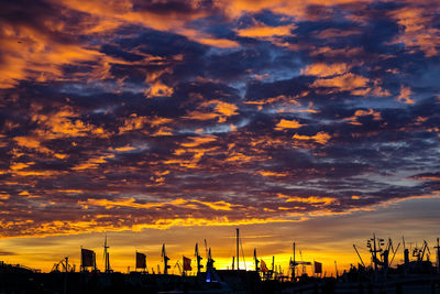 Silhouette buildings against sky during sunset