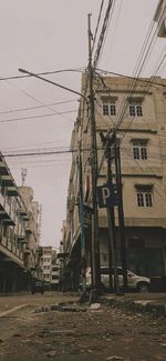 Street against buildings in city against sky