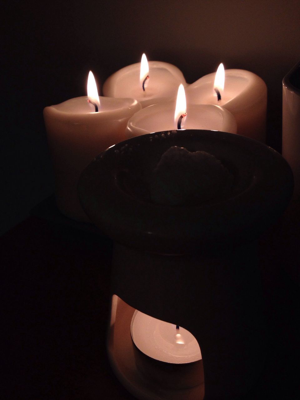 illuminated, indoors, candle, flame, burning, glowing, lit, dark, fire - natural phenomenon, lighting equipment, night, black background, heat - temperature, darkroom, close-up, candlelight, light - natural phenomenon, studio shot, still life, decoration