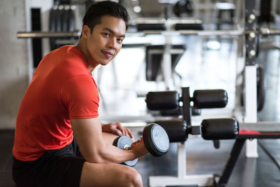 Side view of woman exercising in gym