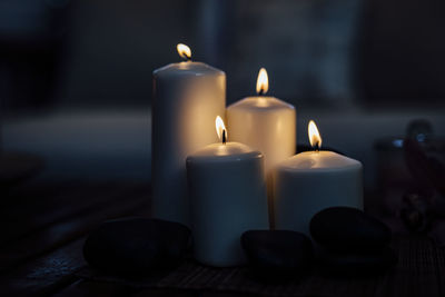 Close-up of burning light candles on table