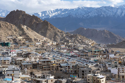 High angle view of townscape and mountains against sky