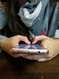 Midsection of woman holding smart phone