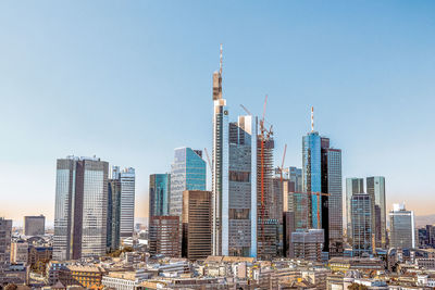 Modern buildings in city against clear sky