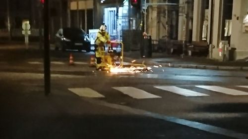 Man on illuminated road