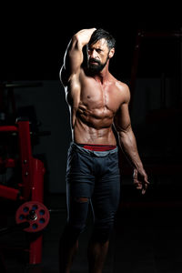 Portrait of young man exercising in gym