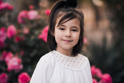 Beautiful smiling kid girl 4-5 year old posing over nature background closeup. looking at camera. 