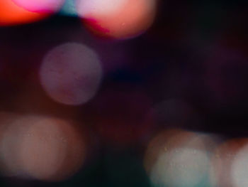 Defocused image of lights against sky at night