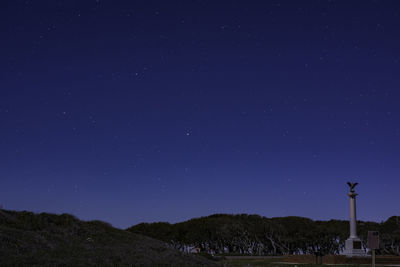 Low angle view of stars against clear blue sky