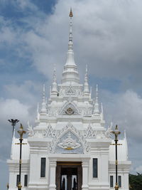 Low angle view of building against cloudy sky