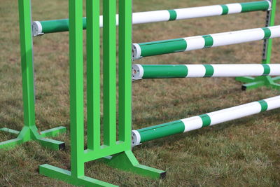 Close-up of metal fence on field