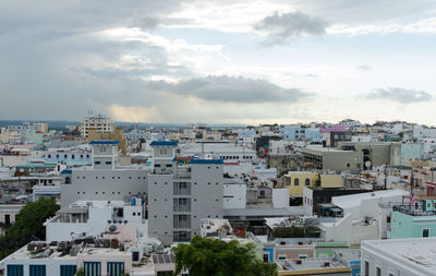 Houses in city against sky