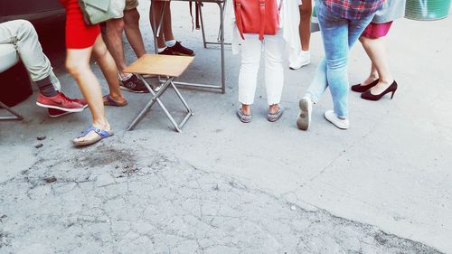 Low section of people standing on tiled floor