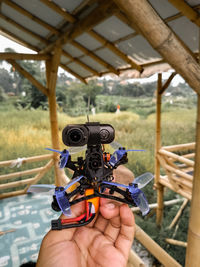 Cropped image of man holding camera