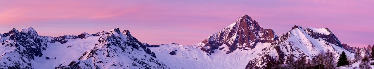 Scenic view of snowcapped mountains against sky during sunset