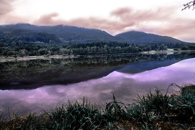 Scenic view of lake and mountains against sky