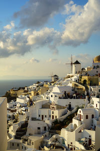 High angle view of townscape by sea against sky