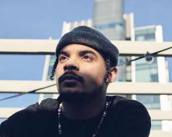 Low angle view of young man standing against building