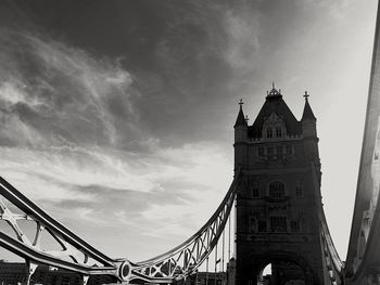 Low angle view of bridge against cloudy sky