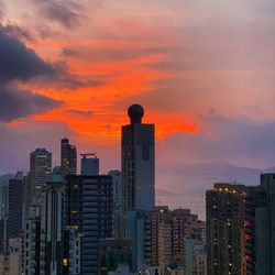 Modern buildings against sky during sunset