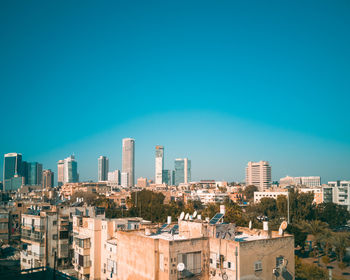 Cityscape against clear blue sky