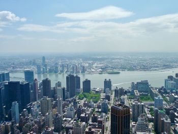 High angle view of cityscape against cloudy sky