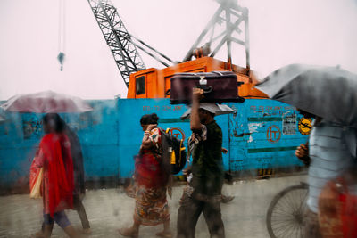 People walking on road in rain