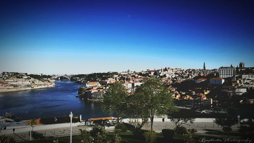 View of cityscape against clear blue sky