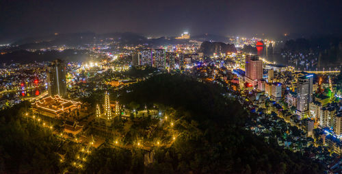 High angle view of illuminated buildings in city at night