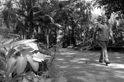 Full length of man with umbrella on tree