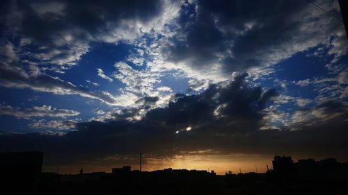 Silhouette buildings against sky during sunset