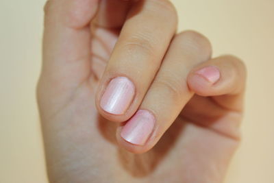 Close-up of woman hand with pink fingernail