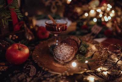 Christmas academia vintage harry potter table - fir, candles, wine, red decor, glasses, gingerbread