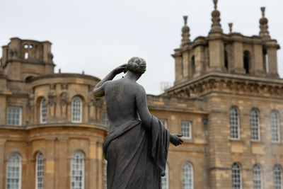 Low angle view of statue against building