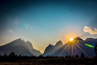 Scenic view of silhouette mountains against sky during sunset