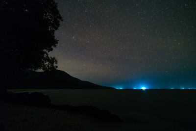 Scenic view of silhouette mountains against sky at night