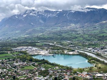 High angle view of city and mountains against sky