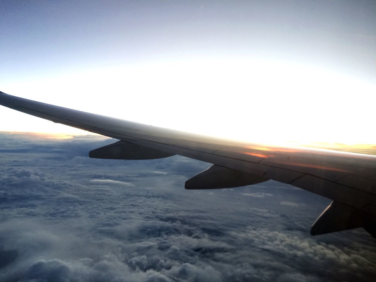 LOW ANGLE VIEW OF AIRPLANE FLYING OVER LANDSCAPE AGAINST SKY