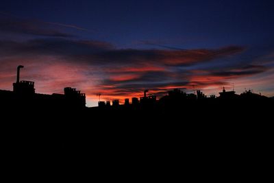 Silhouette buildings against sky during sunset